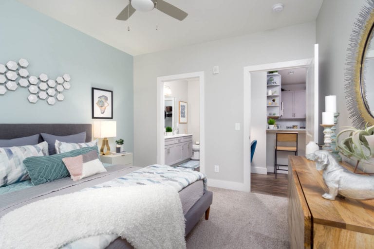 large bedroom with ceiling fan and master bath | The RED apartments